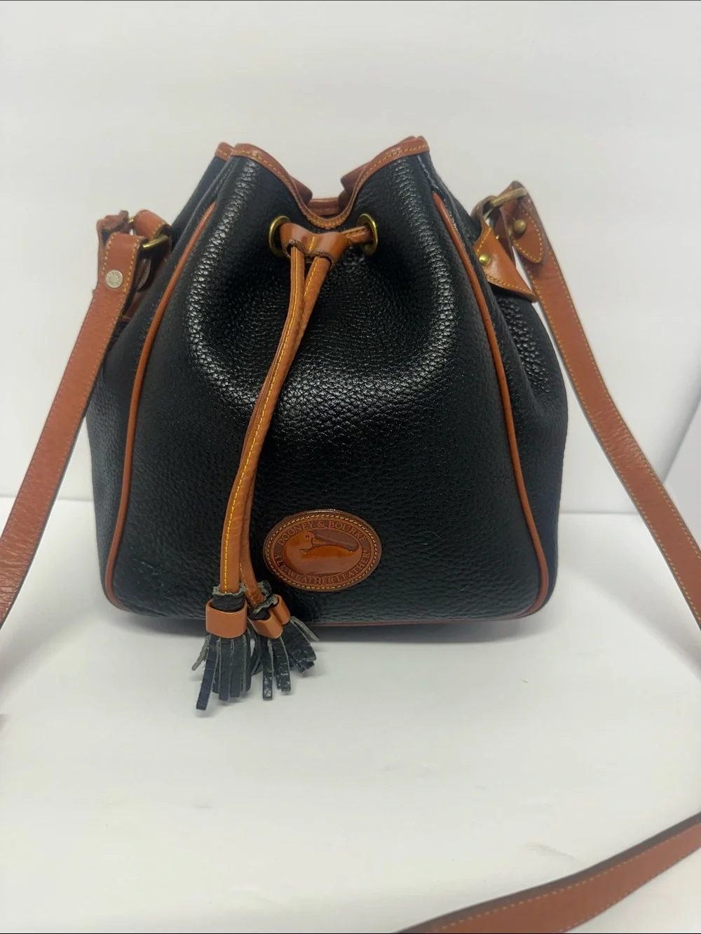 Dooney & Bourke Black Pebbled Leather Drawstring Bucket Bag with Tan Trim
